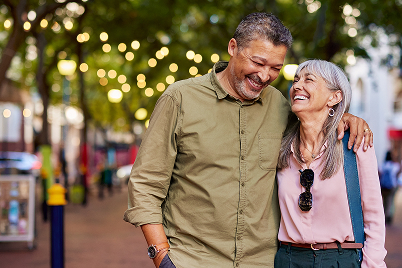 man and woman walking in a downtown city