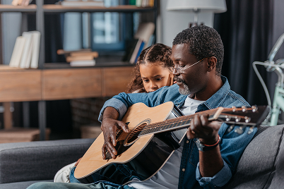 father daughter playing guitar
